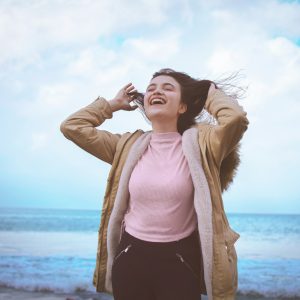Basic Photography woman in pink long sleeve shirt and black pants standing on beach during daytime